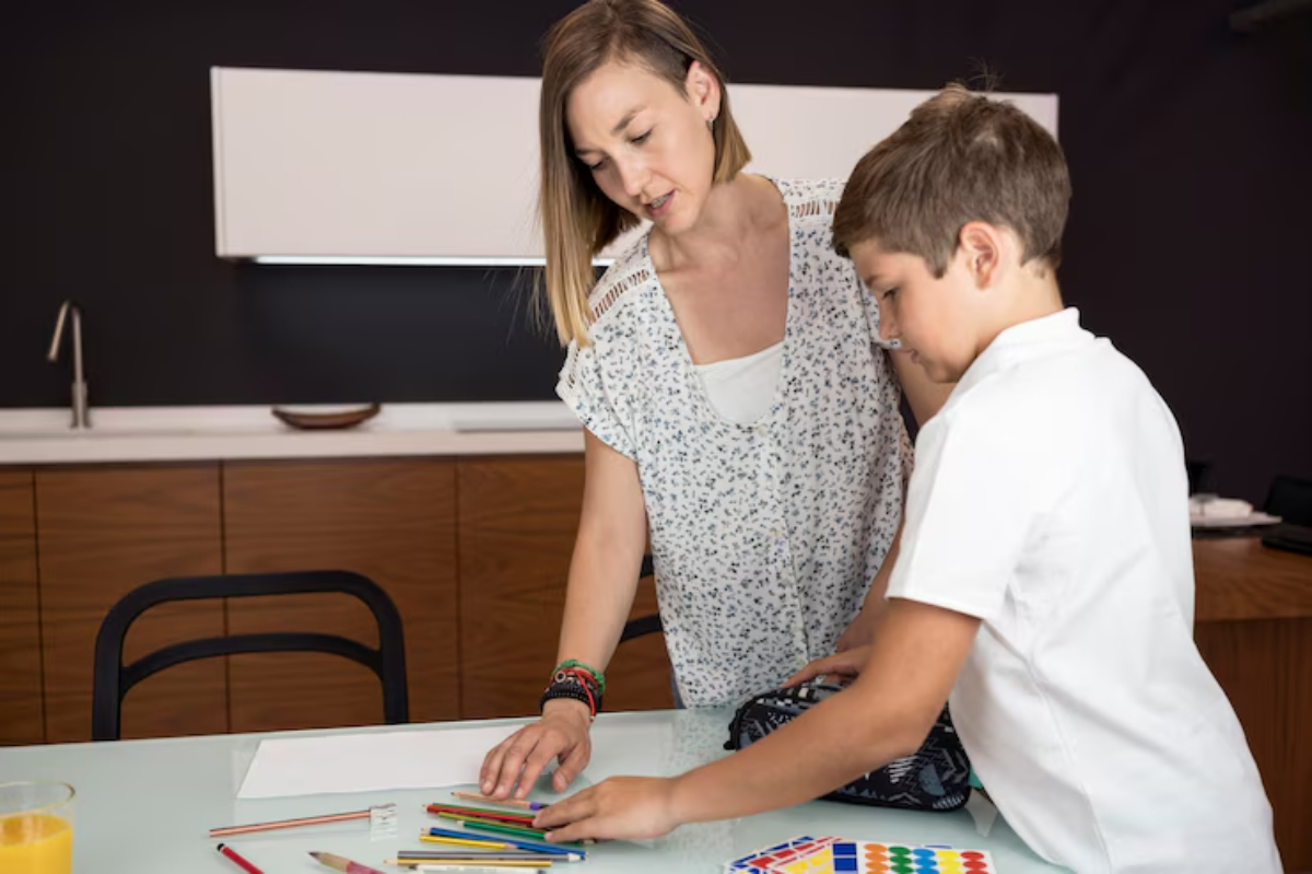 A child and an adult are engaged in a creative activity at a table, surrounded by colorful art supplies and materials.