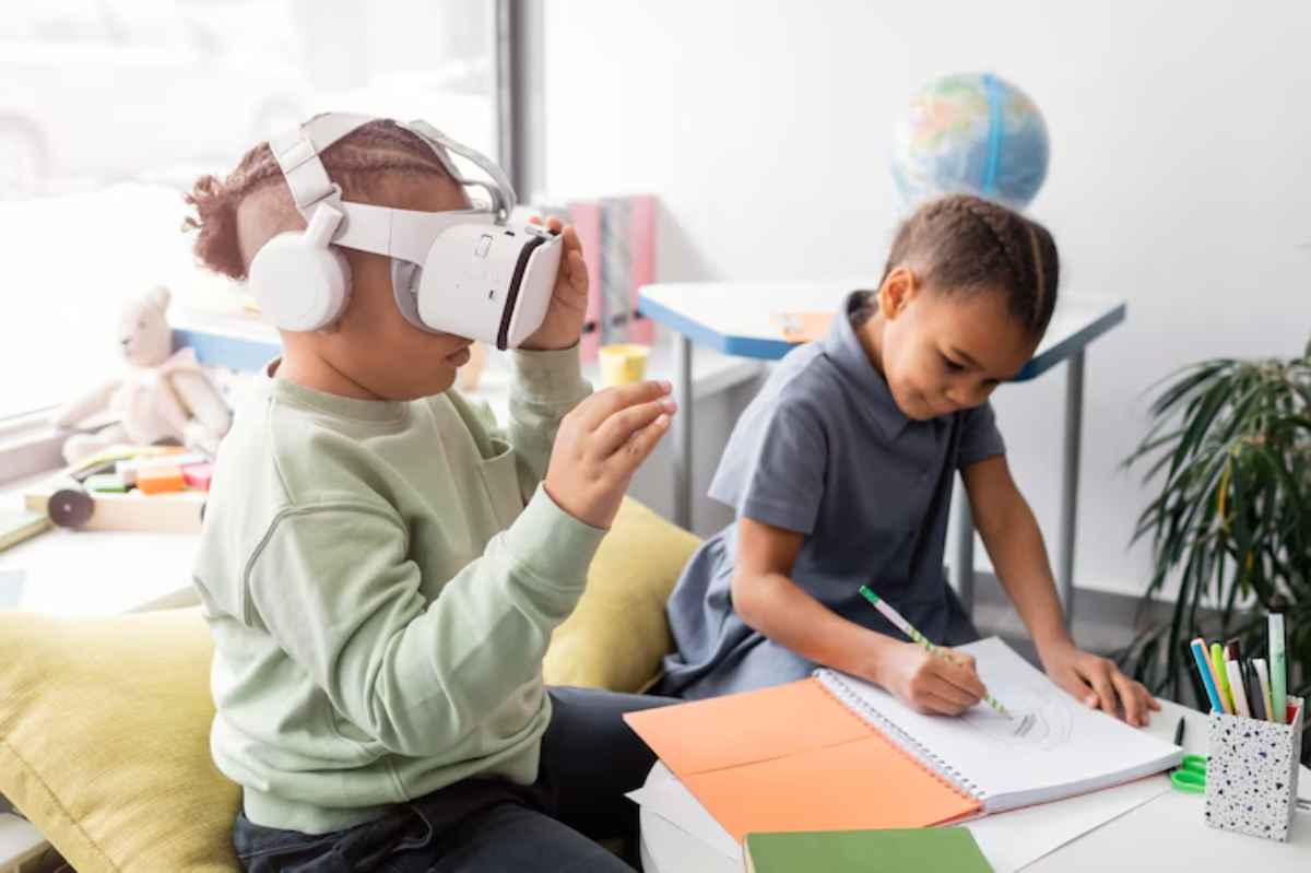 A child with headphones uses a virtual reality headset, while another child draws on a notebook at a colorful, bright workspace.