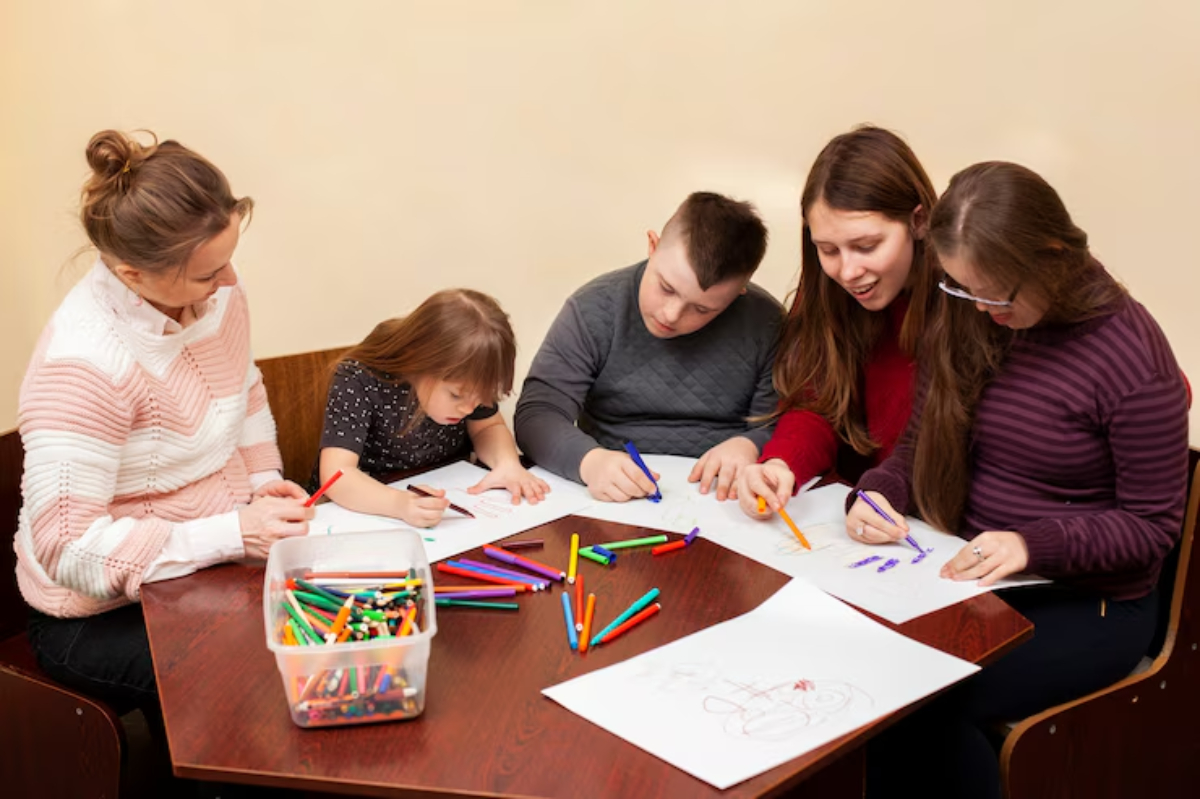 A group of people engaged in coloring activities at a table surrounded by colorful markers and drawings.